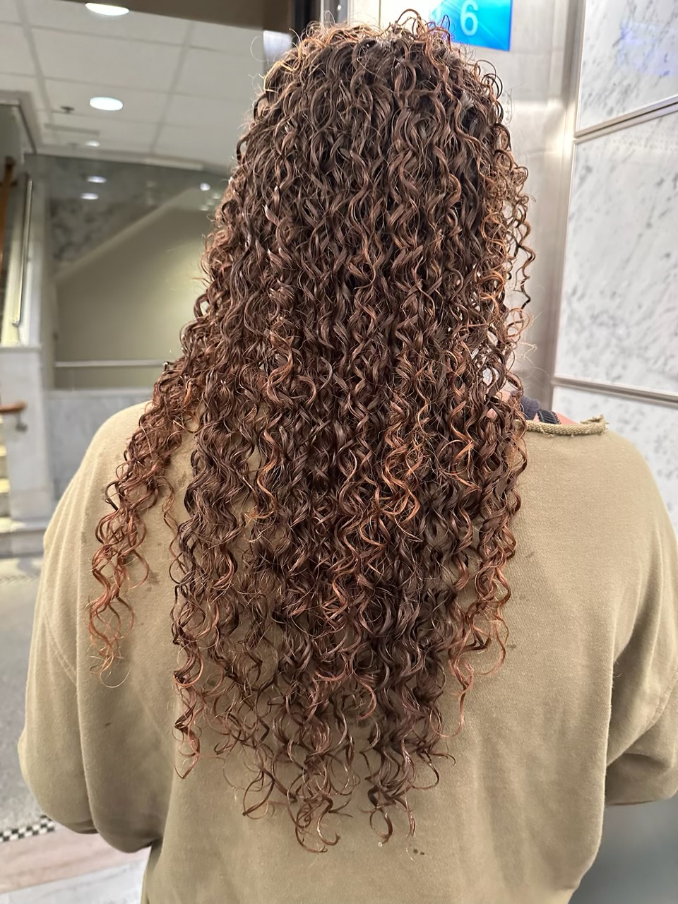 Long defined curly perm created by Hoa Weiland at Straight and Curl Hair Salon